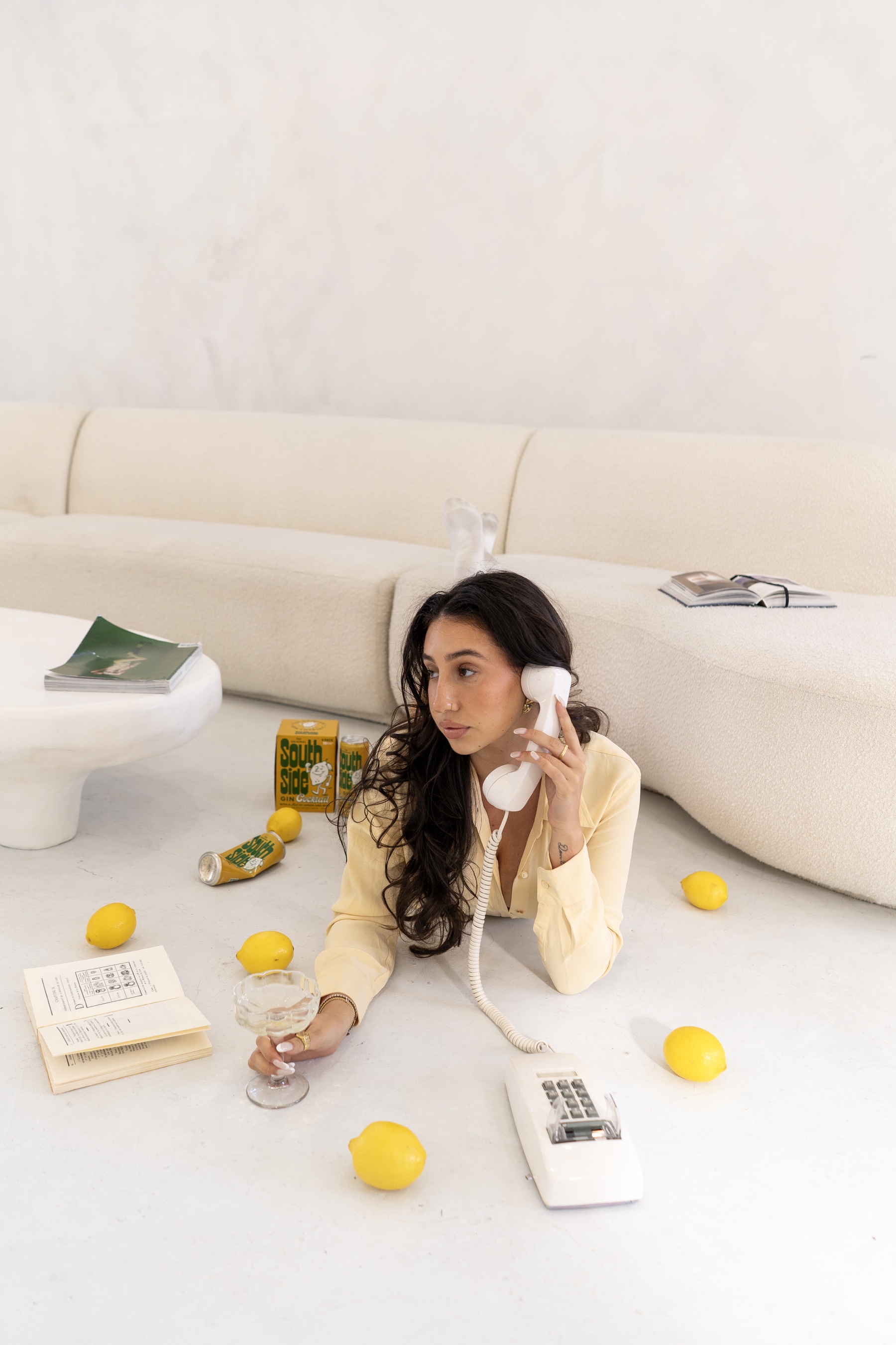 Isadora posing with a telephone in a bright editorial set